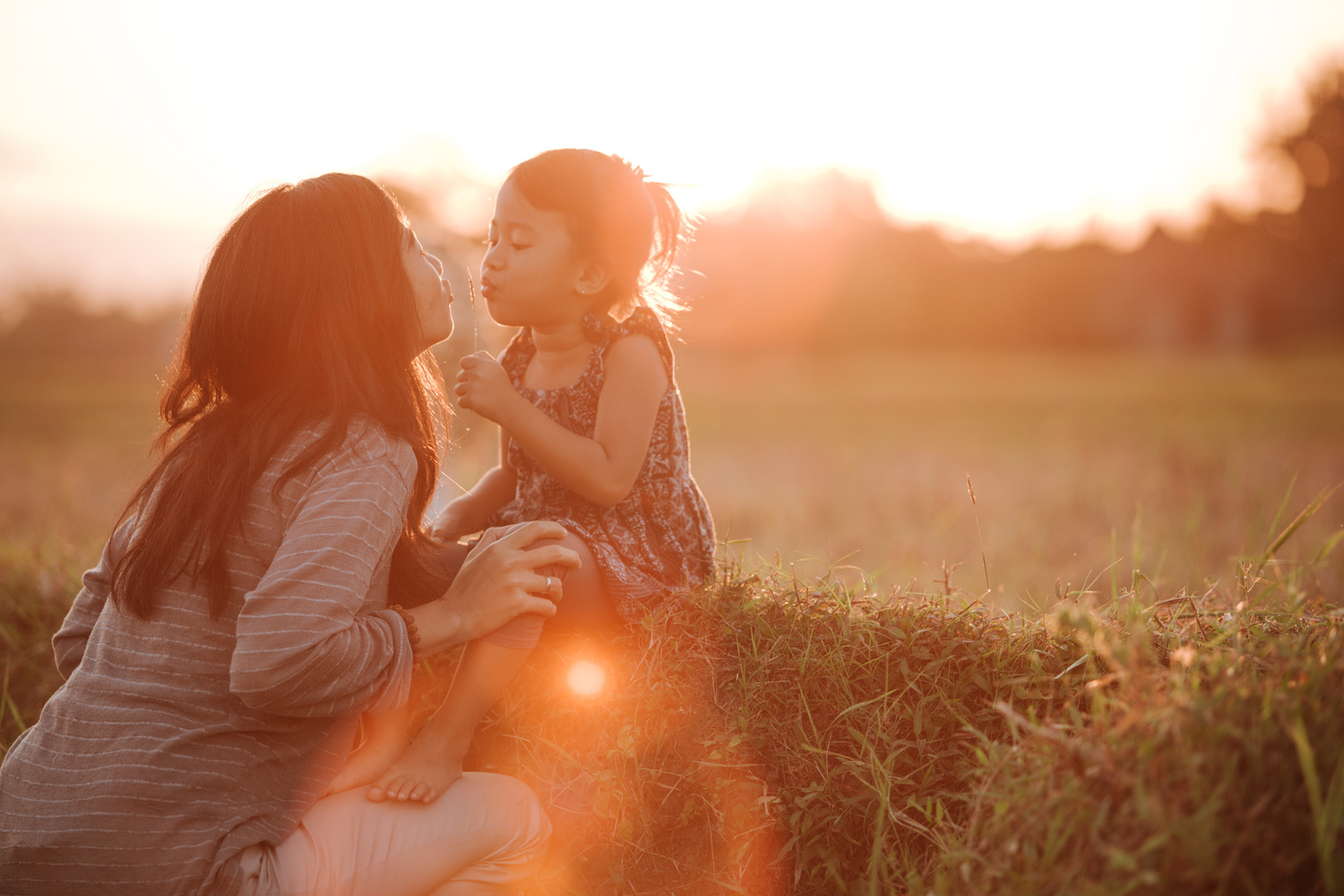 Mom and Daughter in Beautiful Sunset Scenery